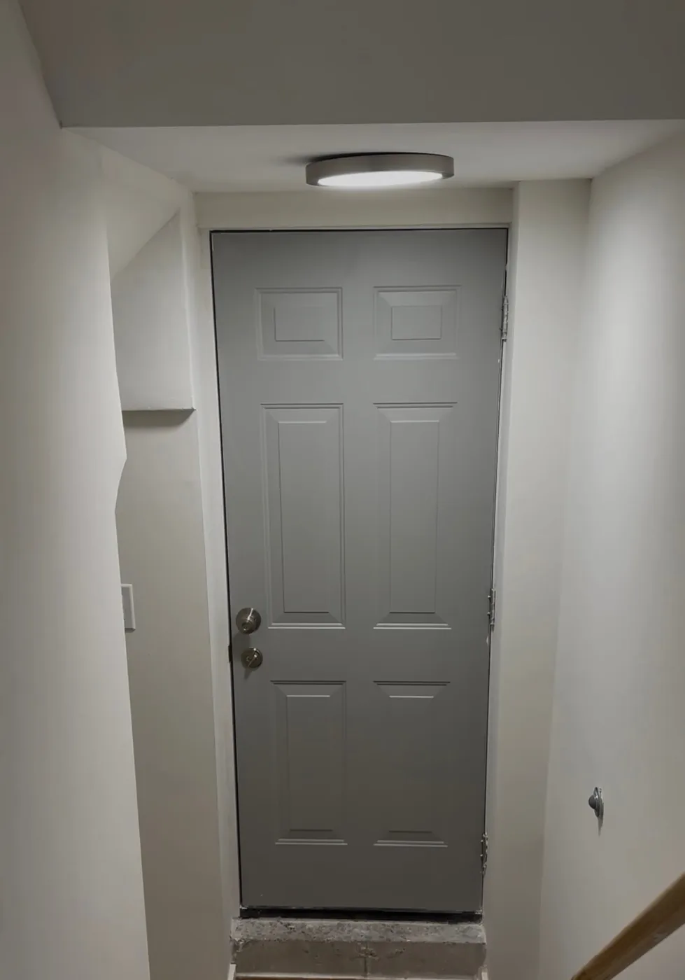 After: new six-panel door hung and trimmed, walls and ceiling finished with a new ceiling light, by Task Magic Handyman