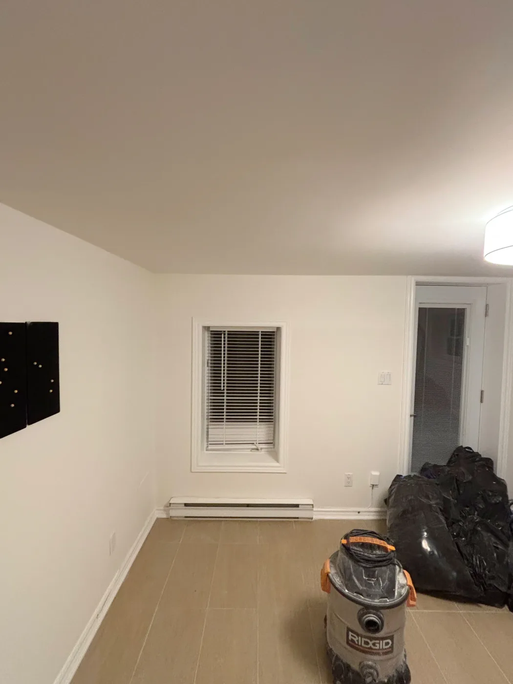 After: the same room with the ceiling and walls re-drywalled and painted