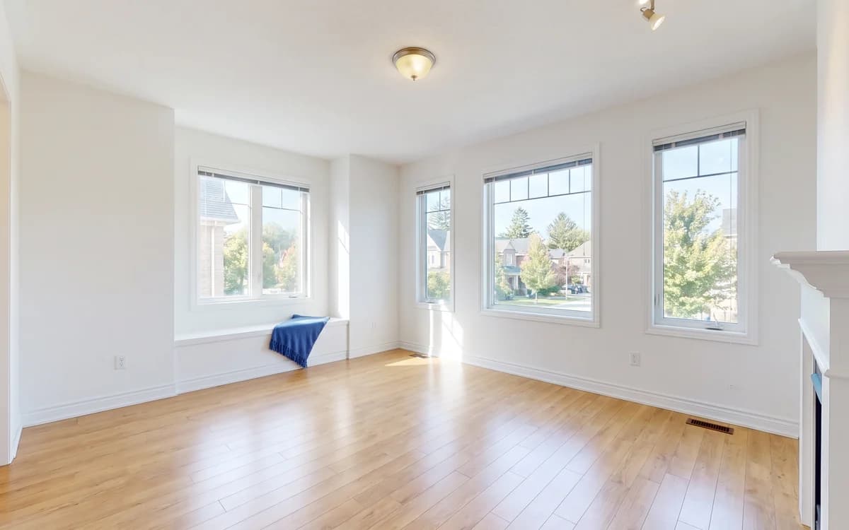 Empty, freshly cleaned room with hardwood floors, ready for a new tenant