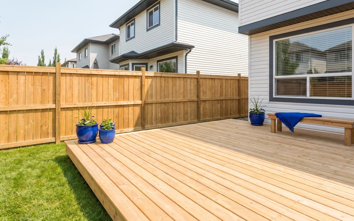 New cedar deck and privacy fence in a backyard